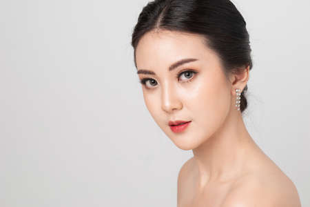 Beautiful makeup Asian woman. portrait Asian girl in studio white background. Cosmetic contact lenses. Beauty and makeup concept.の写真素材