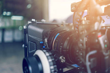 Closeup professional cinema lens behind the scene. Video production equipment.の写真素材