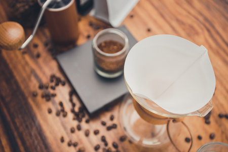 Close up filter coffee on wooden table with zipper bag coffee. The process of making drip coffee.の写真素材