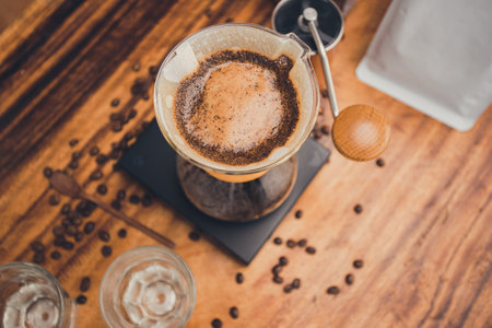 Coffee powder in the dripper for make coffee filter on scales. The process of making drip coffee.の写真素材