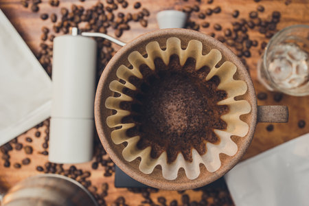 Top view coffee powder in the dripper for make coffee filter on scales. Prepare drip coffee with coffee hand grinder and zipper bag coffee. The process of making drip coffee.の写真素材