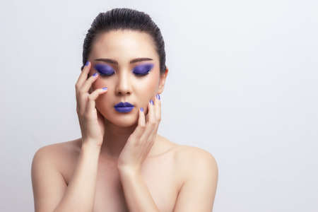 Makeup Asian woman close eyes show blue color eyeshadow with extreme long false eyelashes. Eyelash Extensions. Makeup, Cosmetics, Beautiful cosmetics makeup concept.の写真素材