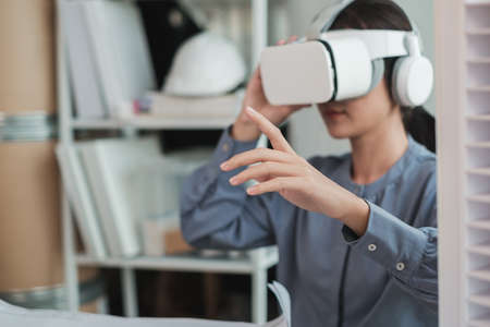 Selective focus on hand of Architect woman using VR headset in office.の写真素材