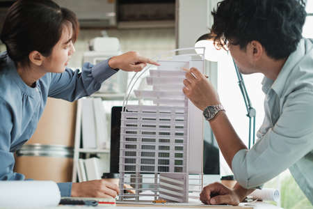 Team architects or engineer designer in office discussing construction project. Young male and...
