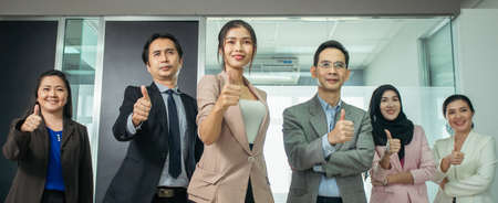Business leaders with professional colleagues group showing thumbs up look forward. Company professional multicultural office team. Asian Business people.の写真素材