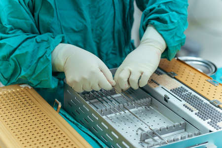 Selective focus, Assistant Orthopedic doctor preparing instruments for operation bone fracture on the table.の写真素材