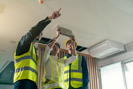 Engineer and architect working discussion plan in construction process interior with augmented reality technology on digital tablet. Concept technology in construction business.の写真素材