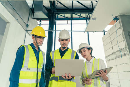 Engineer and architect working discussion plan in construction process interior with augmented...