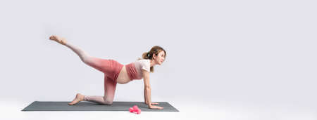 Pregnant Asian woman healthy yoga practice posing on banner white background. Workout yoga and fitness of pregnancy concept.の写真素材