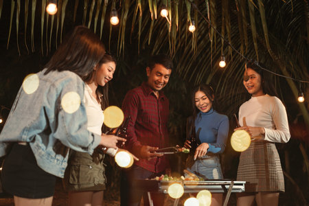 Asian group friends happy dinner party bbq on grill. Friendship and celebration concept.