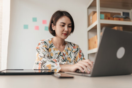Entrepreneur Asian woman using computer laptop at home office. Businesswoman online working. Small business concept.の写真素材