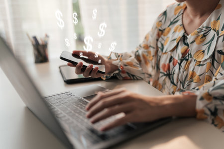 Selective focus hand using smartphone trading. Female hand using mobile phone with online transaction application, earning money income. Concept ecommerce and internet investment.の写真素材