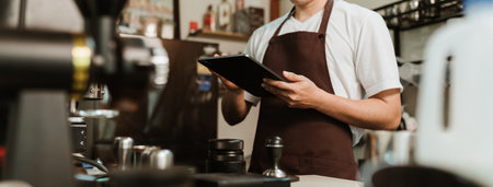 Banner ratio, Closeup hand of barista use digital tablet take orders service at coffee shop. SME business coffee shop concept.の写真素材