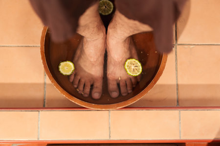 Customer foot in washing bowl for cleaning spa. Relaxing Asian couple customer satisfied with the service massage in spa salon.の写真素材