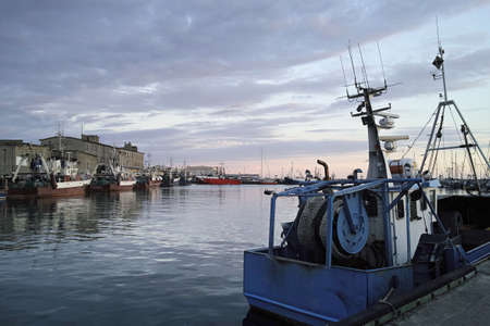 Fishing boats in a harbour early morning