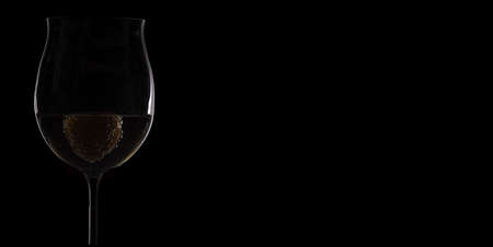 Wineglass silhouette with strawberry as backgroundの写真素材