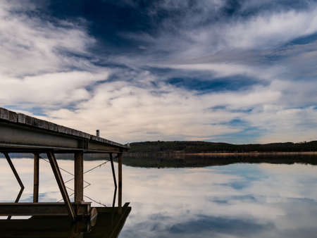 Pier in the sea with very cloudy skyの写真素材