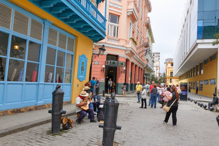 Cheerful street musicians playing on a street outdoors and people watching in Cubaのeditorial素材