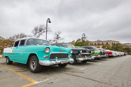 Parking full of classic American cars on a street in Cubaのeditorial素材