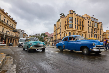Close-up of a classic American car in Cuba with buildings in the background