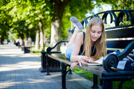 a beautiful girl walks and engaged in self-education preparing for admission to the Universityの写真素材