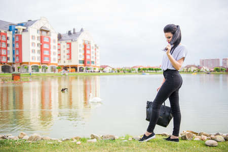 Beautiful girl on the shore of beautiful lake in a beautiful villageの写真素材