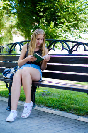 a beautiful girl walks and engaged in self-education preparing for admission to the Universityの写真素材