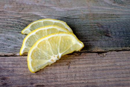 delicious three slices of lemon on wooden table