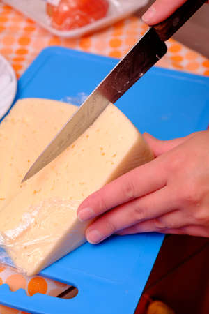 Cuts blue cheese on Boards in the home kitchen.の写真素材