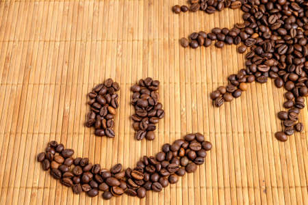 Coffee beans on a wooden tray in the early morning.の写真素材