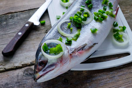 Fresh frozen fish salmon on a cutting board.の写真素材