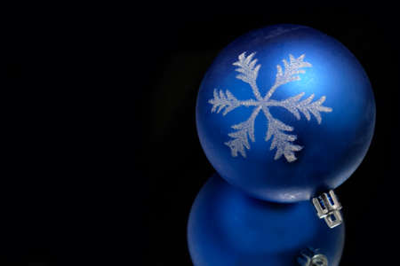 Beautiful new Christmas ball on a black background.の写真素材