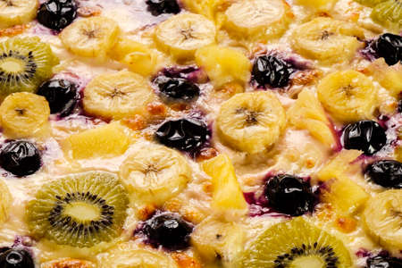 Delicious baked pizza on a white board and a menu of various fresh gourmet ingredients.の写真素材