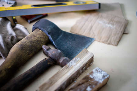 Tools ax and hammer at a construction site in the village of the country.