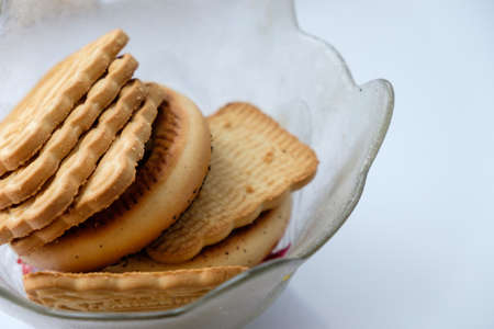 Delicious fresh cookies on the white table, illuminated by the light from the window.の写真素材