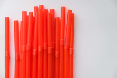 Multicolored tubes for cocktails on a white background illuminated by the light from the window.の写真素材