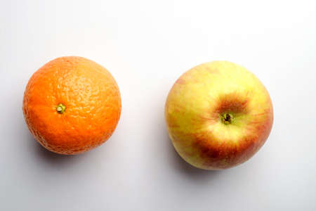 apple and orange on a white backgroundの写真素材
