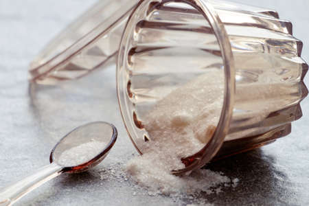 Food salt in plastic jar on the stone background.の写真素材