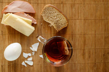 Morning breakfast on wooden background, illuminated by natural light from the window.の写真素材