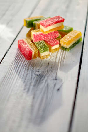 Colorful delicious marmalade on wooden boards, illuminated by the light from the window.の写真素材