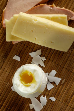 Morning breakfast on wooden background, illuminated by natural light from the window.の写真素材