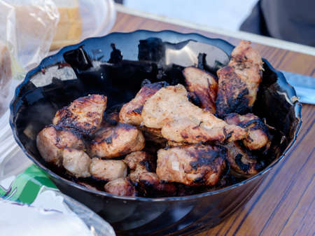 Grilled skewers, sesame seeds and marjoram on a black plate. Studio shotの写真素材