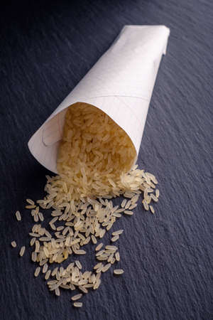 Rice in bags on the black stone board. lit studio lights.の写真素材