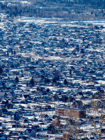 Winter landscape, small houses increased in Siberia, Russiaの写真素材
