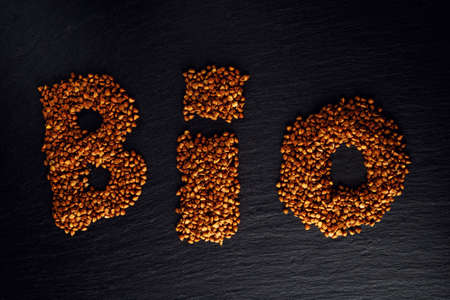 Word Bio seed buckwheat, filmed on a dark stone plaque.の写真素材