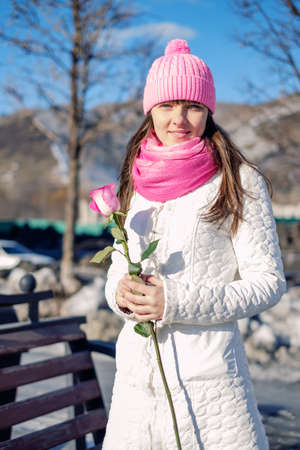 Beautiful girl with a beautiful pink roseの写真素材