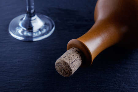 Elegant  wine glass and a wine bottle in black backgroundの写真素材