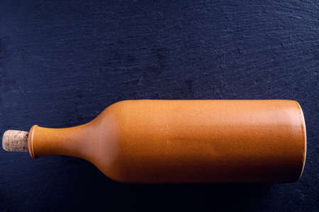 Elegant  wine glass and a wine bottle in black backgroundの写真素材