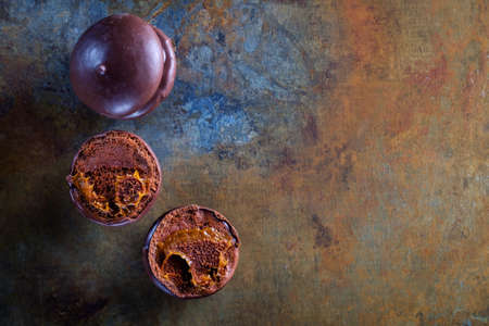 Sweet and colorful macaroon cookies tower on dark background with blank space,selective focusの写真素材