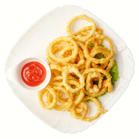 Heap of deep fried onion or calamari rings with chilli dip  on white.の写真素材